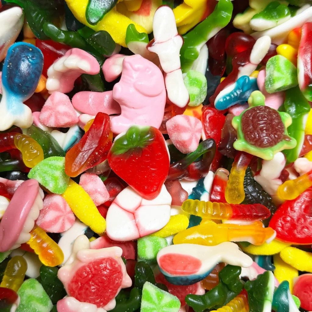 Colorful assortment of gummy candies, including fruits, animals, and various shapes. Ideal for sweet treats or candy-themed events.