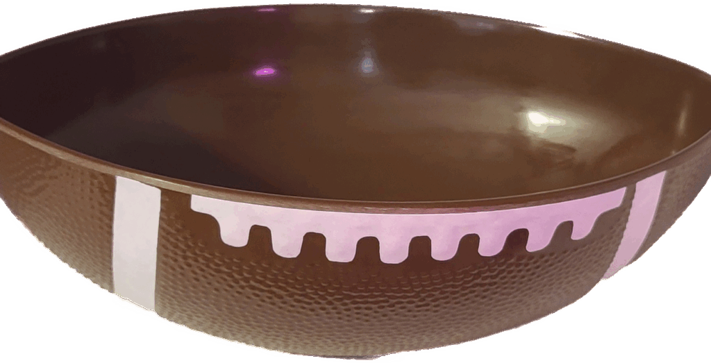 A brown bowl designed to resemble a football, featuring textured sides and white markings. Ideal for sports-themed gatherings or celebrations.