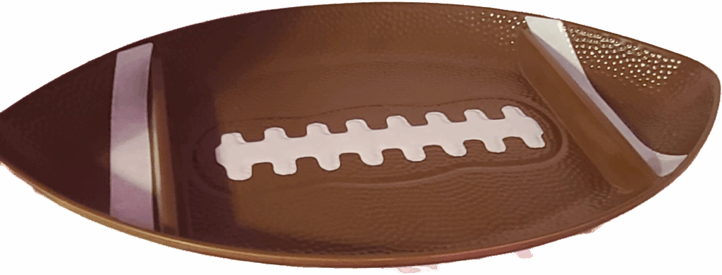 Brown football-shaped serving tray featuring white sections resembling laces, ideal for game day snacks or themed parties.